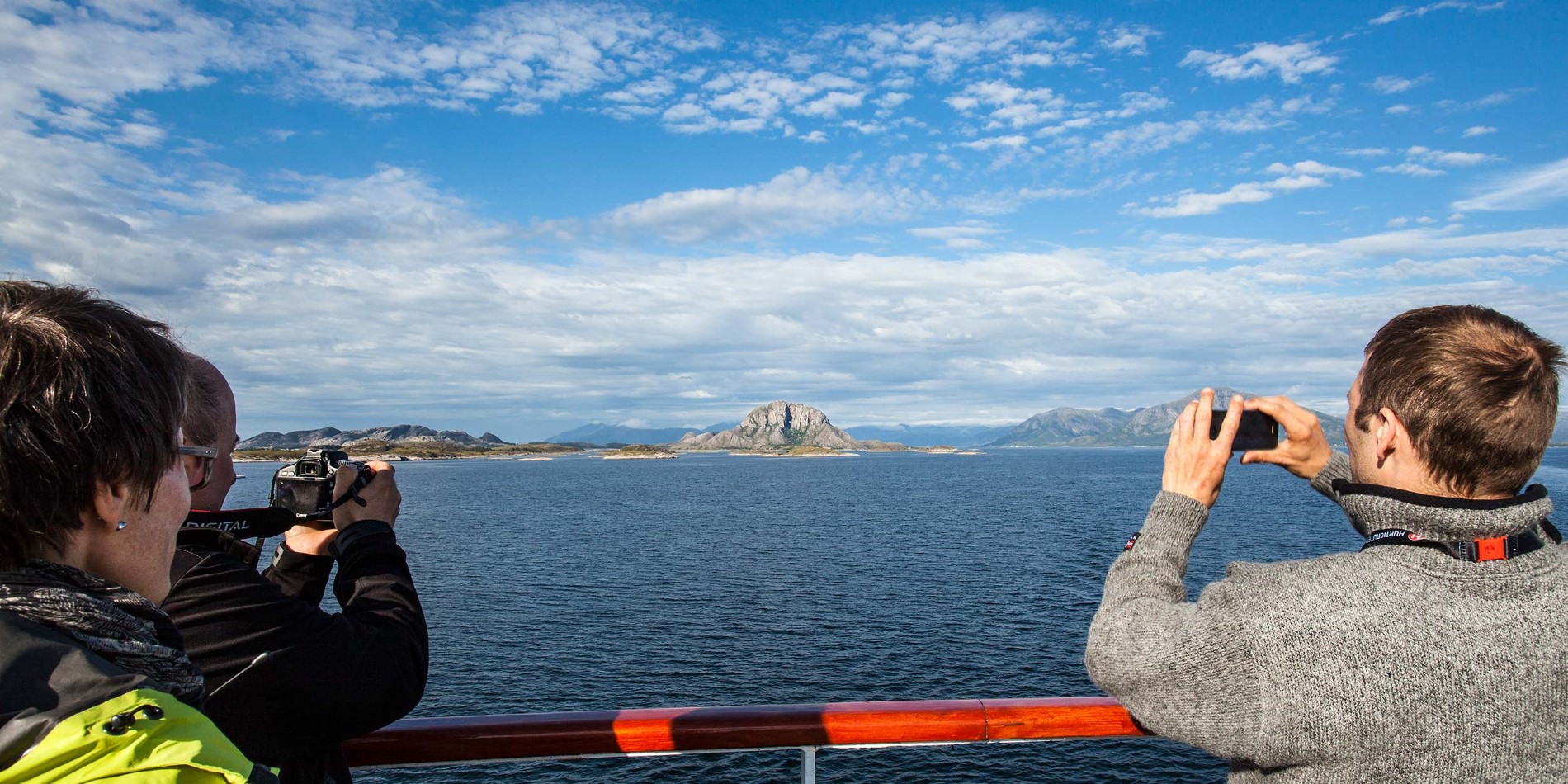 Passengers photographing Torghatten from deck